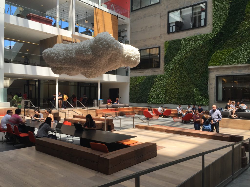 Street-level view of building lobby, collaborative work areas Airbnb SF.